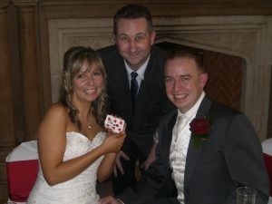 Andy performs an intricate card trick for the bride and groom creating a personal moment of magic as they smile with delight!