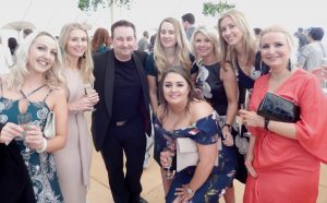 Andy is at a party in Swindon surrounded by a group of guests.
