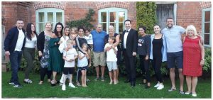 Andy Field standing with an entire family during a celebratory moment