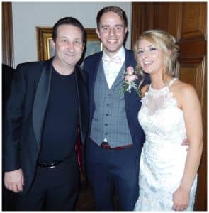 Swindon wedding magician Andy Field posing with the bride and groom after performing close-up magic.