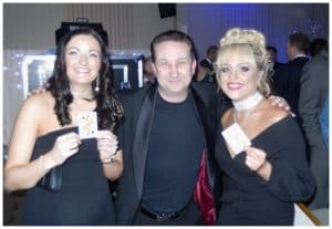 Andy Field engaging two guests with a card trick.