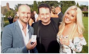 Andy Field close up magician standing between a couple after performing a card trick at a Gloucester event
