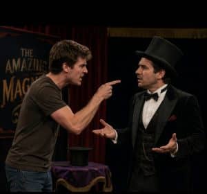 A magician being heckled by an audience member