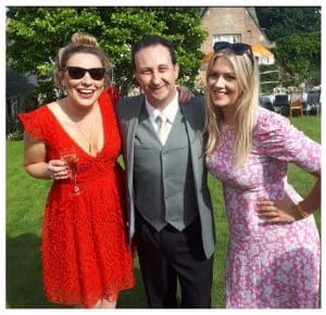 Cheltenham party magician Andy Field performing magic and sleight of hand between two guests at a lively party!