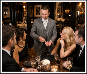 Magician naturally entertaining a small group during a close-up performance