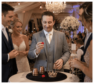 Bristol party magician Andy Field performing the cups and balls close-up magic trick to amazed guests