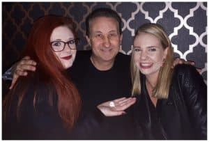Two guests taking part in an interactive close-up magic trick with Bristol party magician Andy Field