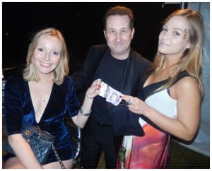 Andy Field performing an interactive money magic routine with guests holding the banknotes
