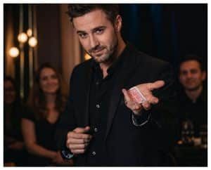 Magician making eye contact with a spectator while performing a card trick