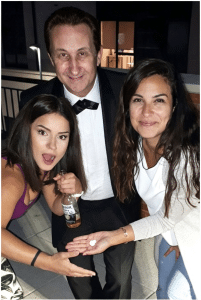 Oxford anniversary magician performing an interactive magic trick for two ladies