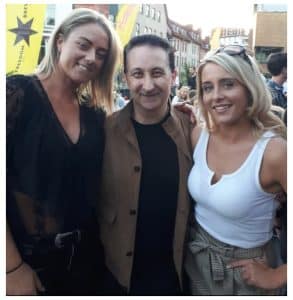 Andy Field posing with two smiling guests after performing close-up magic at a Bristol party
