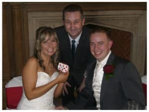 Bath magician Andy Field performing a card trick for a bride and groom