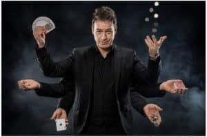 Magician demonstrating misdirection during a close-up magic performance