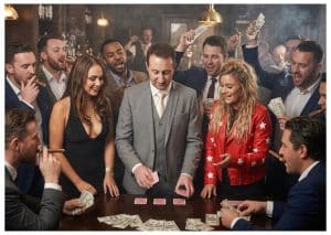 Magician performing close-up magic for a group of spectators