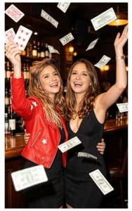 Two women throwing money in the air at a Swindon wedding