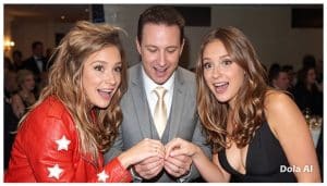 Two women looking away from a magician's hands during a magic performance